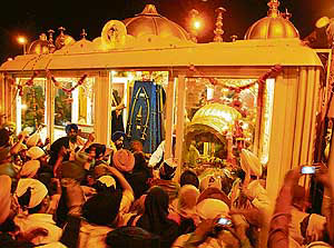Devotees having darshan of Gurus weapons and relics during Guru Manyo Granth Jagriti Yatra in Chandigarh on Saturday.