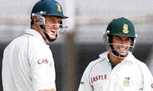 South African cricketers Graeme Smith (left) and Neil McKenzie congratulate each other after setting a new world record for the maximum runs (414) scored by opening batsmen in the history of the game, during the second day of the second Test between Bangladesh and South Africa at the Chittagong Divisional Stadium.