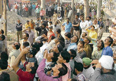 A crowd which gathered on the NH-73 in Yamunanagar on Sunday where a man was found hanging from a tree.
