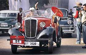 Dr Vijay Chandra (left) drives a 1937 Morris 8 vintage car as his companion waves after the flag-off of the 42nd Statesman Vintage & Classic Car Rally 2008 in New Delhi