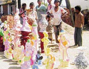 Toys and idols on display on a roadside near the Police Lines in Sangrur.