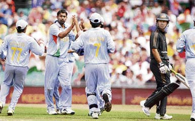 Praveen Kumar is congratulated by teammates after bowling out Australia's captain Ricky Ponting for 4 runs during the first final of the tri-nations one-day international cricket series at the Sydney Cricket Ground, Sunday