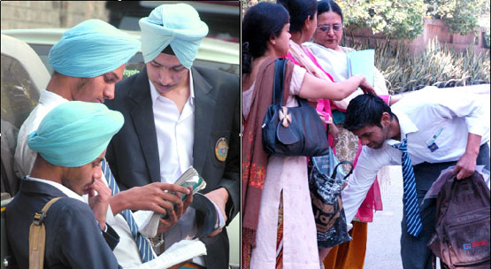 Some CBSE examinees continue consulting notes while others seek blessings of their parents at Modern School in the Capital on Monday.