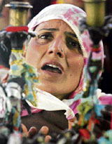 A Muslim woman cries at the shrine of Sufi Saint Sheikh Hamzah Makhdoomi on his birth anniversary in Srinagar on Monday.