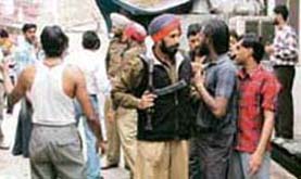 Policemen try to effect a compromise between two warring groups in Ludhiana