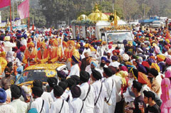Devotees throng the Guru Manyo Granth Jagriti Yatra in Mohali on Monday.