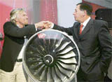 This handout photo shows Virgin Atlantic president Sir Richard Branson (L) as he shakes hands with 