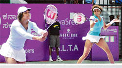 Venus William (right) and her sister Serena Williams in action during their doubles match against Tamarine Tanasugarn of Thailand and Andreea Ehritt-Vanc of Romania at the Bangalore Open