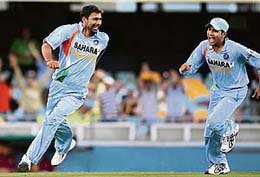 WRECKERS-IN-CHIEF: Praveen Kumar (left) is jubilant after dismissing Ricky Ponting while Sachin Tendulkar plays a shot during the second final of the tri-series between India and Australia in Brisbane on Tuesday. 