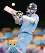 WRECKERS-IN-CHIEF: Praveen Kumar (left) is jubilant after dismissing Ricky Ponting while Sachin Tendulkar plays a shot during the second final of the tri-series between India and Australia in Brisbane on Tuesday. 