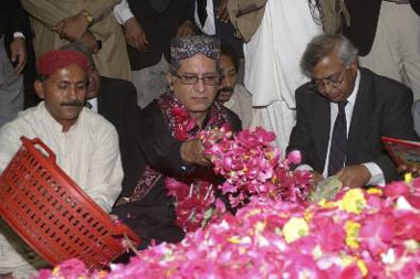 Aitzaz Ahsan, a lawyer of sacked Chief Justice Iftikhar Chaudhry and a leader of slain opposition leader Benazir Bhutto's Pakistan People's Party, lays flowers at her grave in Garhi Khuda Bukhsh on Tuesday.