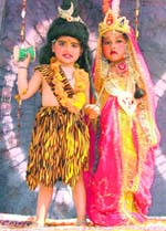 Children dressed up as Shiva and Parvati in a tableau during a Shobha Yatra held on the eve of Shivaratri in Ludhiana on Wednesday. 