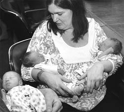 Identity crisis! Allison Penn looks at her identical triplets, (from left), Logan, Eli and Collin, at North Shore University Hospital in Manhasset, New York