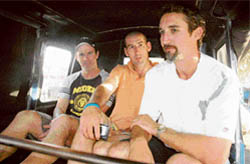 Australian cricketers Jason Gillespie (right), Mathew Elliot (centre) and their trainer take a three-wheeler ride in Sector 11, Chandigarh