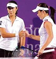 Chinas Shuai Peng (L) and Tiantian Sun congratulate each other after beating Venus and Serena Williams of the USA at the Bangalore Open on Wednesday night.