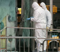 The New York bomb squad investigates an explosion, outside the U.S. Armed Forces Career Center in New Yorks Times Square on Thursday.