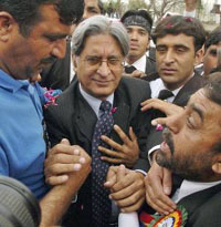 President of Pakistans Supreme Court Bar Association Aitzaz Ahsan (centre) is greeted by lawyers as he arrives to address them in Rawalpindi on Thursday.