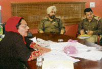 Jagjit Kaur, managing director of the newspaper, and the police team in the office of Rozana Spokesman in Mohali on Friday.