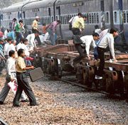 Stranded passengers board a train after a snag in the Northern Grid hit train services in Faridabad on Friday.