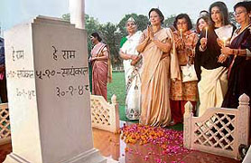 Mahatma Gandhi's granddaughter Tara Bhattacharya (2nd from right) during the candlelight vigil around Martyr's Column, the place of martyrdom of Gandhiji, after a conference on "Gandhiji's Parliament: The voice of women and justice at Gandhi Smriti" on the eve of International Women Day organised by the Women's Political Watch in New Delhi on Friday. 