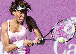 Venus Williams of the USA hits a return to Russias Vera Zvonareva in the quarterfinal of the WTA Bangalore Open