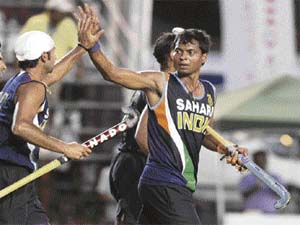 Dilip Tirkey (R) celebrates with Prabhjot Singh after scoring against Austria during the hockey qualifier in Santiago