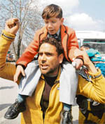 An SRTC employee along with his son during a protest demonstration against the state government in Srinagar