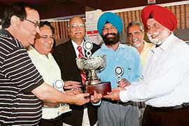 The PEC team receive the trophy after winning the Engineers Golf Championship at the Chandigarh Golf Club on Sunday. 