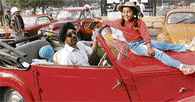 A girl enjoys during the vintage car rally flaged off from the Lake Club in Chandigarh on Sunday.