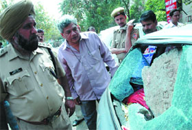 CPI (M) politburo member Sitaram Yechuri looks at his car damaged in a clash between workers of the BJP/RSS and the CPI (M) at the latter's office in the Capital on Sunday. 