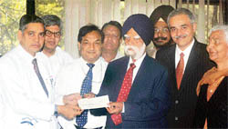 Dr K.K. Talwar, director, PGIMER, Chandigarh, receives a cheque for Rs 1 lakh from Dr K.S. Raju, former IAS officer, as contribution to the poor patient fund on Monday.