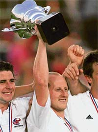 Great Britains captain Ben Hawes holds the trophy after winning the final