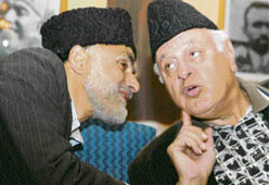 Former chief minister and National Conference patron Dr Farooq Abdullah talking to senior NC leader Ali Mohd Sagar during a press conference after six PDP members joined the NC in Srinagar