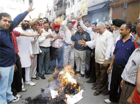 Sewing machine traders burn an effigy of union minister of steel Ram Vilas Paswan in protest against rising steel prices in Ludhiana on Monday.