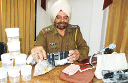 CIA official showing the articles recovered from accused 