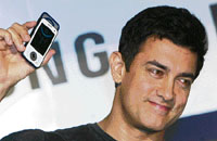 Bollywood actor Aamir Khan holds a new Samsung mobile phone at a promotional event in Mumbai on Wednesday.