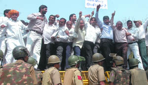 BJP activists try to jump cordon while demonstrating against the CPM in the Capital on Wednesday.
