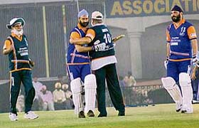 A Congress player congratulates Parminder Singh Dhindsa who scored a 50 in the match
