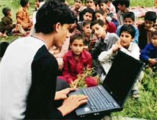 Children belonging to Gujjar and Bakkarwal tribe learning to work on a laptop at a government primary mobile school at Mansar near Jammu.