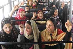 Family members of State Road Transport Corporation employees protest against the government inside a bus in Srinagar on Thursday.