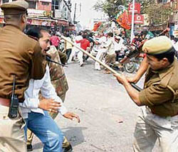 Policemen cane charge BJP workers demonstrating against CPM general secretary Prakash Karat at Hussain Ganj crossing in Lucknow on Thursday.