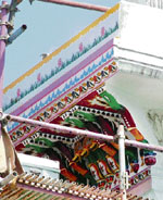 A part of the upper portion of Darshani Deori in the Golden Temple being repainted with gaudy colours.
