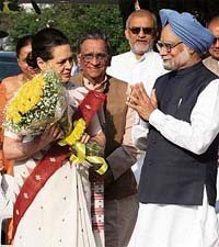 Prime Minister Manmohan Singh felicitates Sonia Gandhi for successfully completing 10 years as party president at her residence in New Delhi