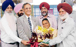 Mohinder Singh Dosanjh and his wife Mohinder Kaur receive awards from Punjab Agricultural University vice-chancellor M.S. Kang at a Kisan Mela in Ludhiana