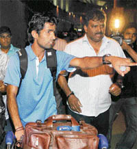 Coach Joaquim Carvalho (R) with player Shivendra Singh at the Chhatrapati Shivaji Airport in Mumbai in the wee hours of Wednesday.