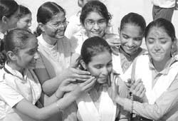 Girls celebrate holi on the last day of their exams at Ambala Public School in Ambala