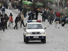 Protesters throw debris at a police vehicle in Lhasa on Friday.
