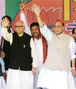 Senior BJP leader L.K. Advani and party president Rajnath Singh wave to the crowd during the vijay sankalp rally at the HUDA ground in Jind on Sunday. 