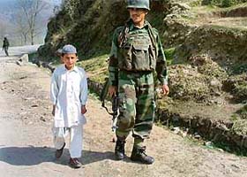 A child talks to an armyman after offering Namaz at a mosque at Shindra in Poonch