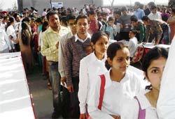 Students stand in queue to participate in a recruitment drive in Mandi Gobindgarh on Sunday.